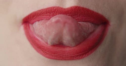 Woman's Red Lips and Tongue Extreme Close-Up