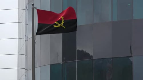 Angolan Flag Waving on a Modern Building Flagpole