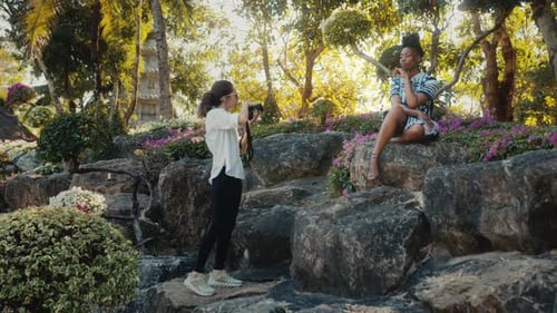 Model Posing for Photographer in a Lush Garden