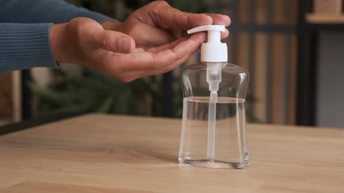 Close-up of Man Using Hand Sanitizer Gel To Prevent Spreading Virus or Bacteria.