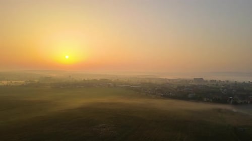 Aerial View Foggy Sunrise Over Residential Houses in Suburban Rural Area