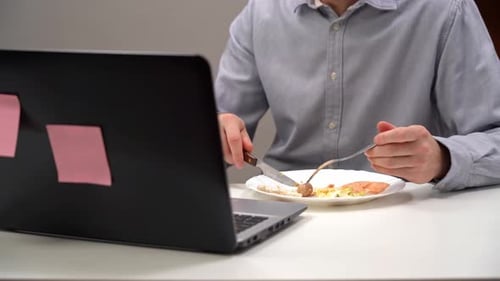 A Young Office Worker a Manager Eats His Diet in His Home Office During Isolation a Pandemic