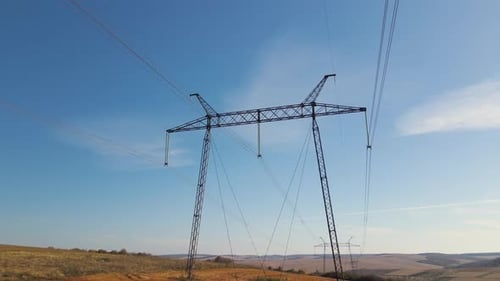 Electrical Power Line Towers Across Rural Landscape
