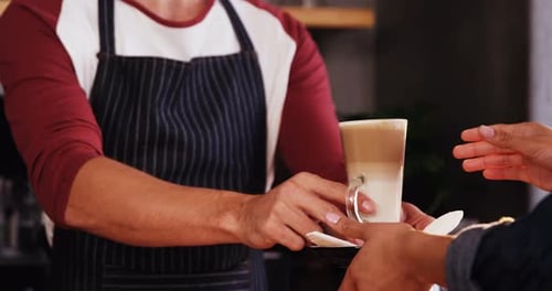 Close up of customer taking his coffee at counteer