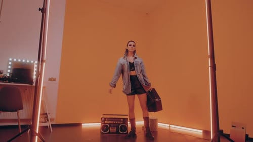 Woman Carrying a Vintage TV in Studio