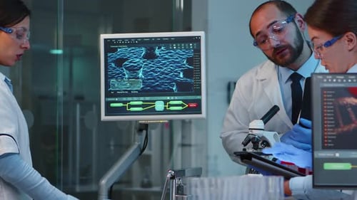 Researchers Collaborating on Scientific Project in Modern Lab