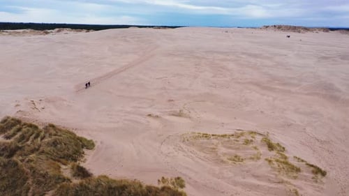 People Exploring Expansive Sand Dunes Aerial View
