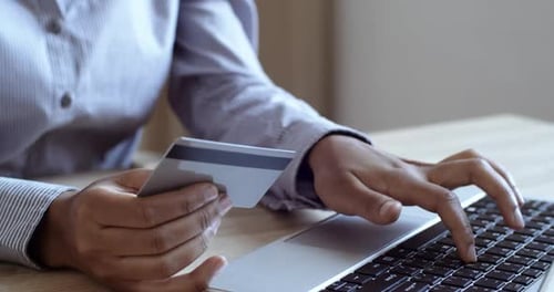 Close Up of Female Hands of Cardholder Holding Credit Bank Card Making Payment