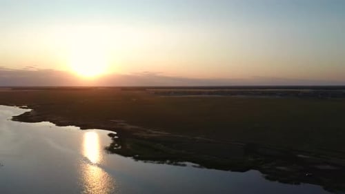 Aerial View Flight Over the Beautiful River in the Green Fields