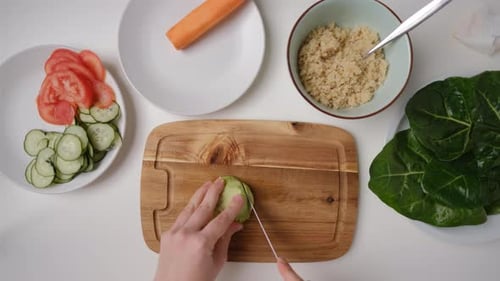 Top view Female hands cut an avocado Cooking Salad.