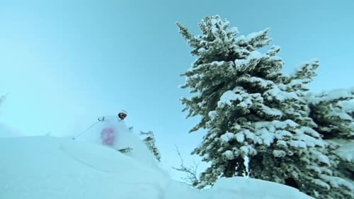 Skier Descending Snow Covered Mountain in Winter