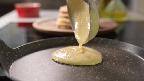 Pancake Batter Cooking on Hot Pan in Kitchen