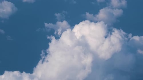Aerial View From Airplane Window at High Altitude of Earth Covered with Puffy Cumulus Clouds Forming