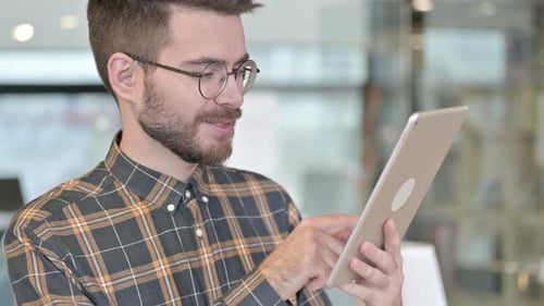 Portrait of Young Designer Using Tablet in Office