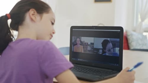 Child Attends Online Class and Holds up Drawing