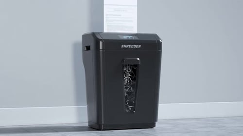 Side view at the paper shredder working. Documents shredding. Office. 4KHD