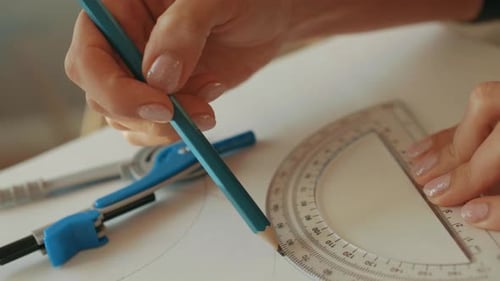 Woman Drawing with Protractor and Compass