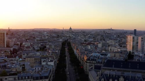 Aerial view of Paris France skyline rooftops sunset.