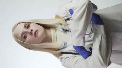 Young Doctor Puts on Blue Surgical Gloves