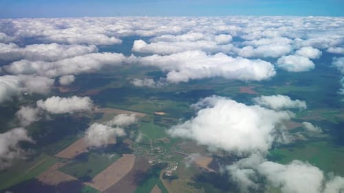 Flight Over the Picturesque Clouds and Green Earth.