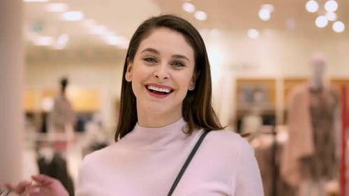 Portrait of smiling woman with full shopping bags