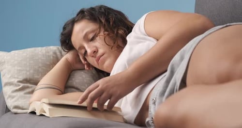 Woman Enjoying a Book on the Sofa