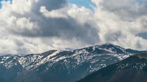 Majestic Mountains Under Clouds on a Sunny Day