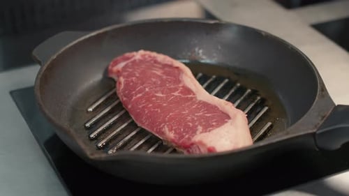 Close Up of Steak Sizzling in Pan