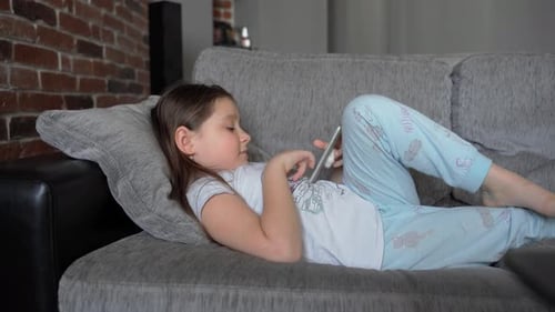 Girl Relaxing With Phone on the Couch
