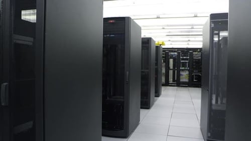 Technician Inspecting Servers in a Data Center