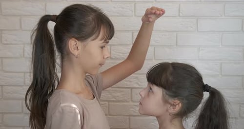 Children measure height.
