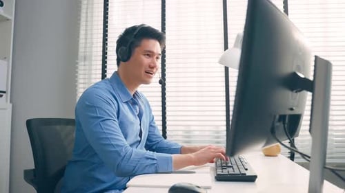 Asian businessman use laptop computer video call with office colleague.