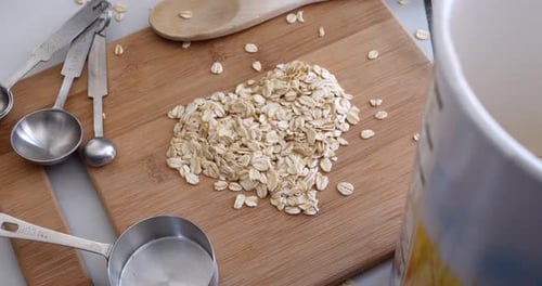 Rolled Oats in Heart Shape on Cutting Board