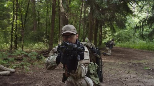 Soldat avec mitrailleuse couvrant une escouade militaire au point d'évacuation