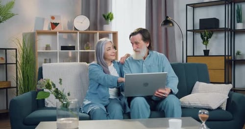 Senior Couple Using Laptop Together on Couch