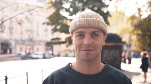 Close Up Portrait of Young Smiling Hipster, Man Looking at Camera, Walking on Street of Town Center