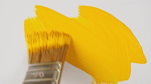 Abstract Brushstrokes of Yellow Paint Brush Applied Isolated on a White Background