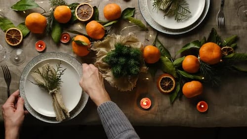 Holiday Table Setting with Oranges and Candles