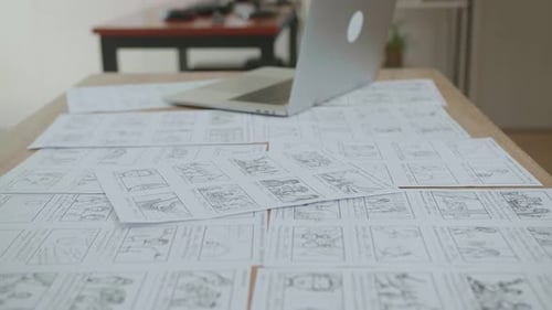 Storyboard and Laptop on a Table