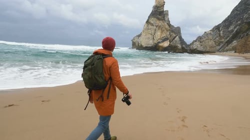 Photographer Takes Picture of Distant Cliffs on Ocean Beach