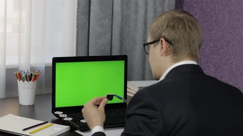 Man Teacher Making Online Video Call on Laptop. Green Screen. Distance Education