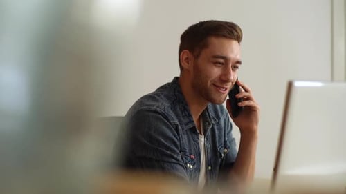 Closeup Face of Smiling Handsome Man Talking Mobile Phone at Home Office Looking Away Side View