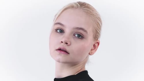 Blonde Woman Poses in Front of White Background