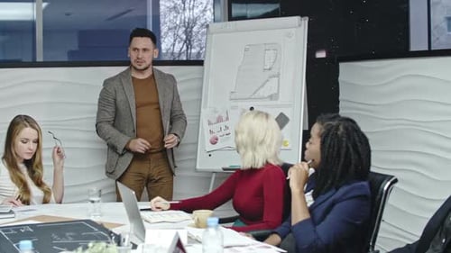 Business Team Discusses Architectural Plans in Office