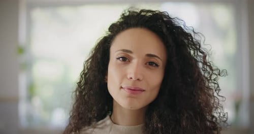 Portrait of a Beautiful Young Woman with Curly Hair