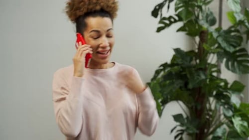 Smiling Woman Talking on Red Cell Phone