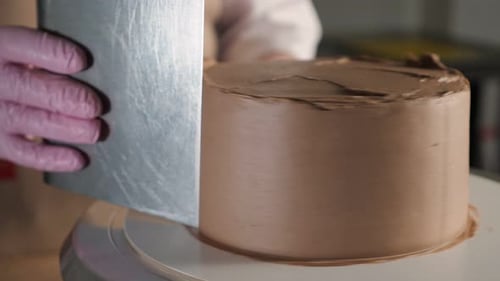 Smoothing Chocolate Cake Frosting with Spatula Close Up