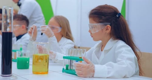 Children Doing Science Experiment in School Laboratory