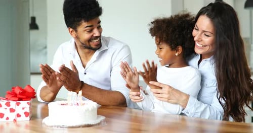 Family Celebrates Birthday at Home with Cake