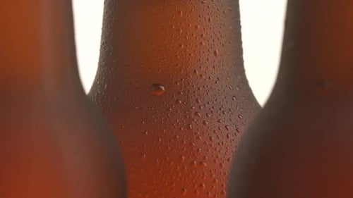 Close Up of Water Droplets on Dark Glass Bottles
